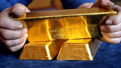 Золото перешло к снижению на дорогом долларе